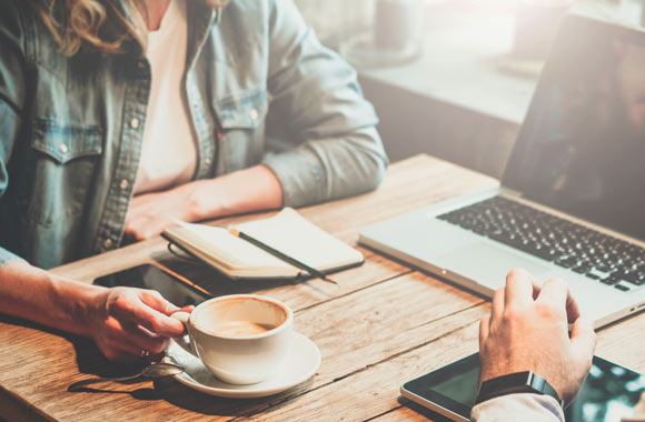 Coffee and laptop with conversation